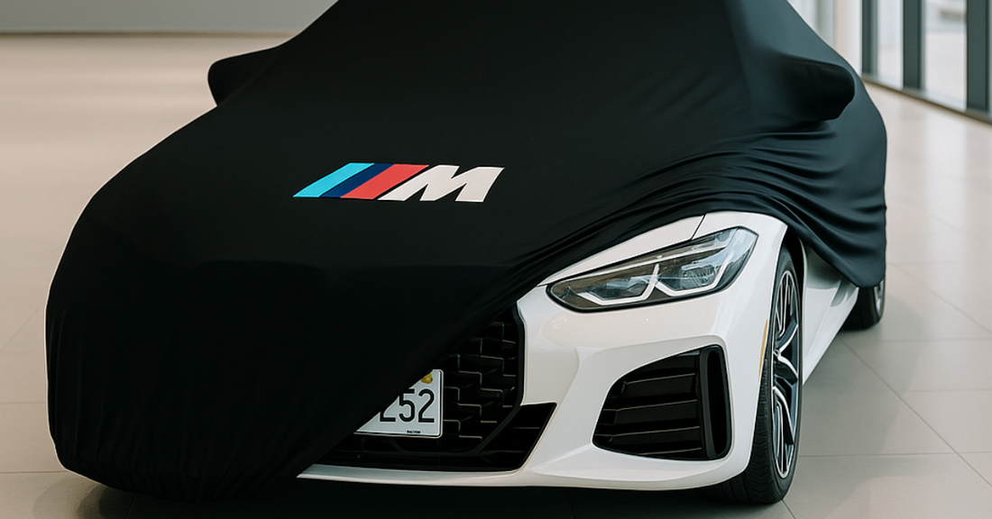 BMW M3 indoor car cover with centered logo in a modern garage