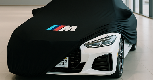 BMW M3 indoor car cover with centered logo in a modern garage