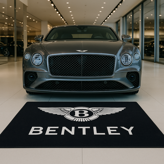 Premium Bentley Motors winged logo floor rug, 5x7 feet (60x87"), with non-slip backing in a luxury car gallery.
