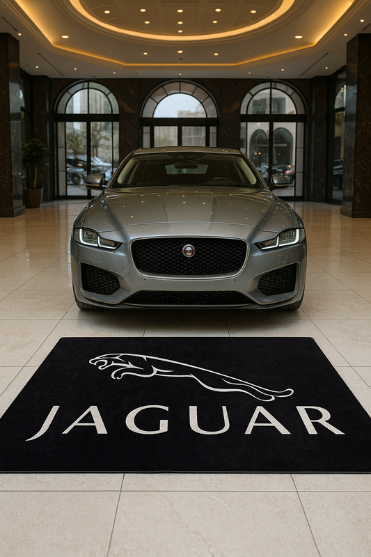 Large Jaguar Leaper logo floor rug, 5x7 feet (60x87 inches), with professional non-slip backing, displayed in a modern luxury car studio.